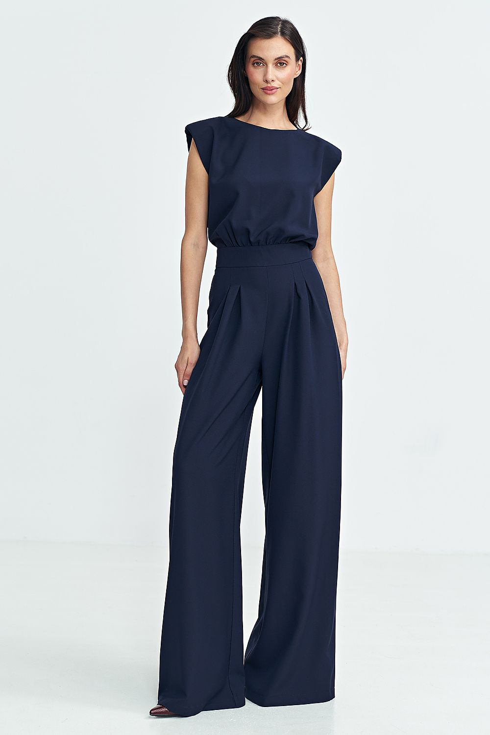 Elegant Boat Neck Jumpsuit by Nife with Shoulder Pads, showcasing a fitted waist and wide Palazzo Pants for a luxurious look at special occasions.