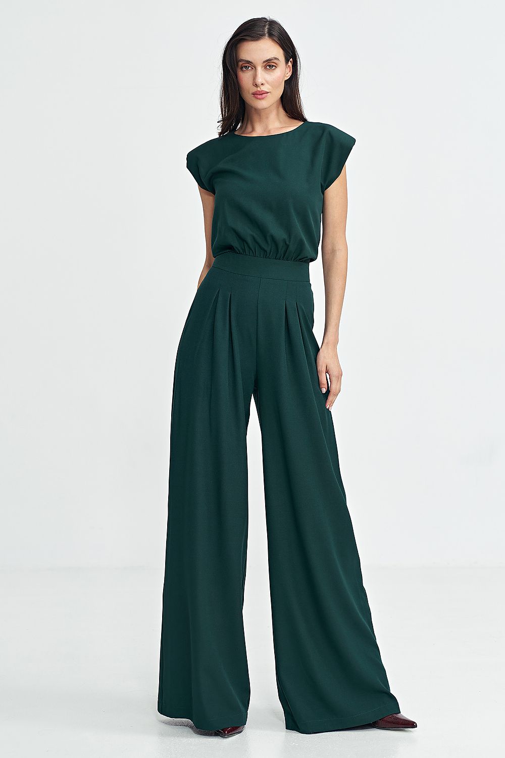 Elegant Nife boat neck jumpsuit featuring shoulder pads and palazzo pants, perfect for special occasions.