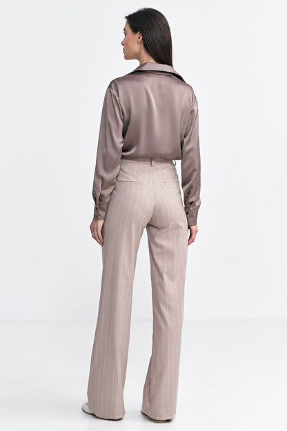 Nife bootcut trousers styled with a modern top, emphasizing the sophistication and versatility of haute couture women's fashion.