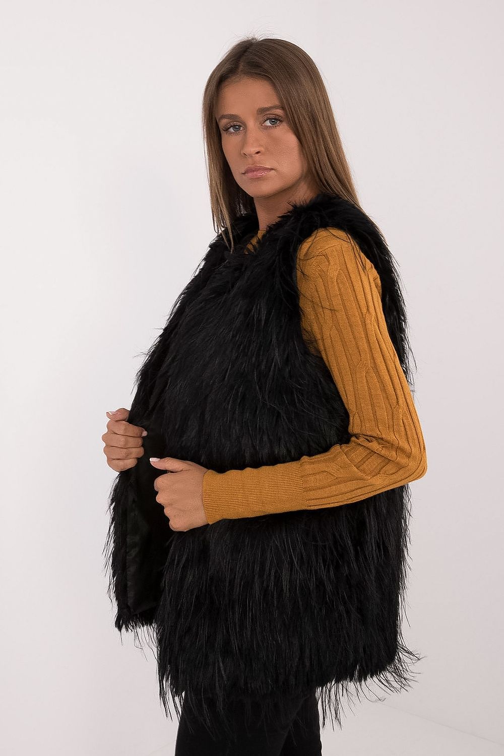 Side view of AT's elegant women's fur vest, made from high-quality polyester, illustrating its perfect fit and layering potential.