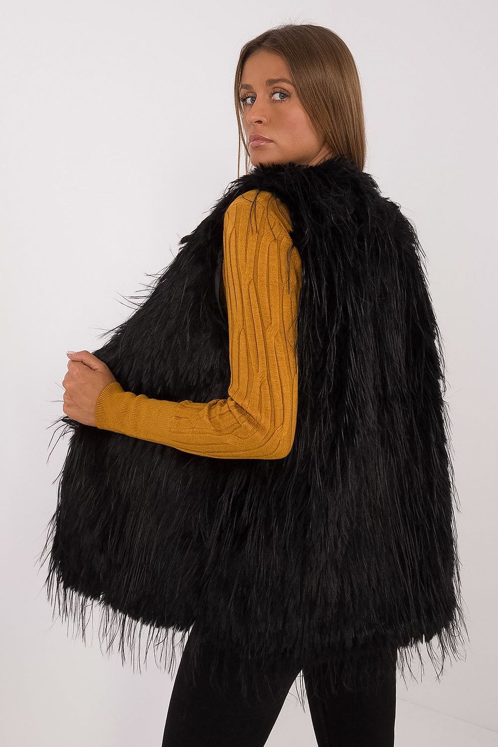 Full-length image of a woman styled in AT's elegant casual fur vest, epitomising luxury and comfort for everyday elegance.