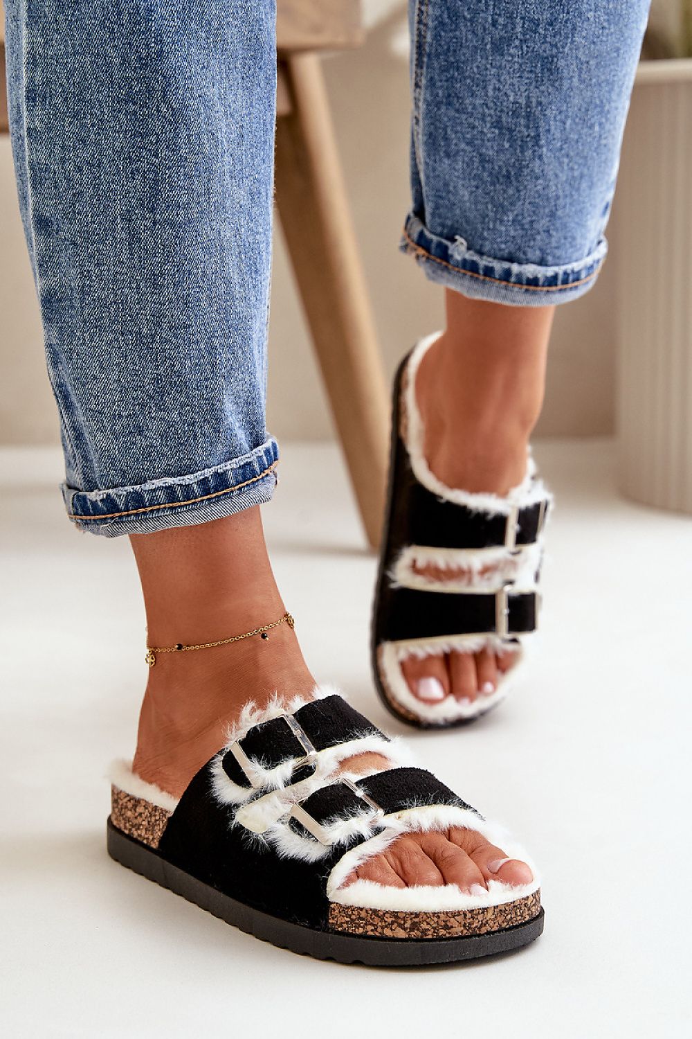 Stylish women's slippers by Step in Style, showcasing adjustable buckles and soft fur to encapsulate luxury and comfort.