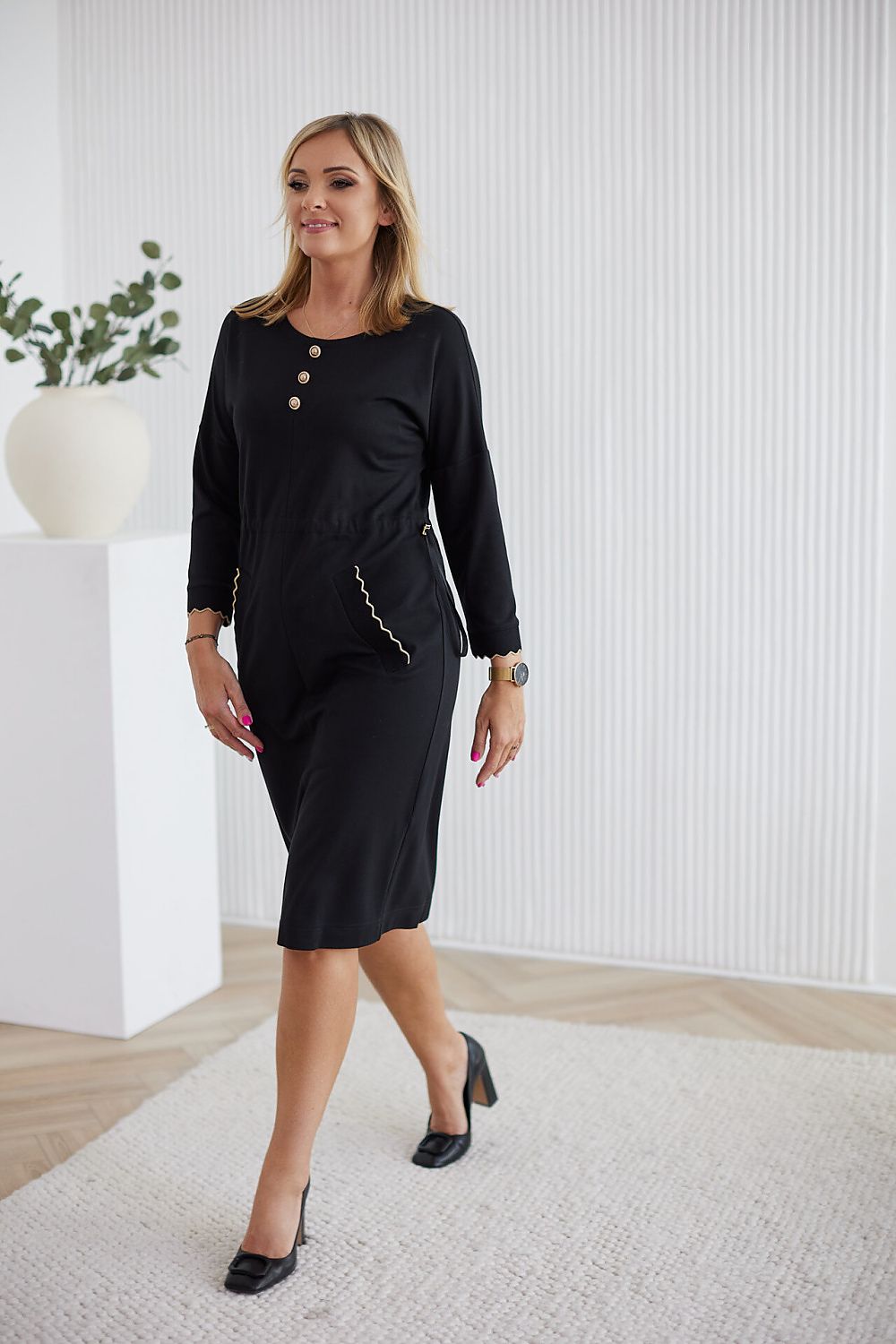 Detail shot of La Aurora luxurious women's daydress showcasing decorative metal buttons and flattering kimono sleeves.