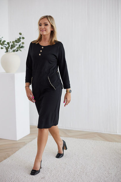 Detail shot of La Aurora luxurious women's daydress showcasing decorative metal buttons and flattering kimono sleeves.