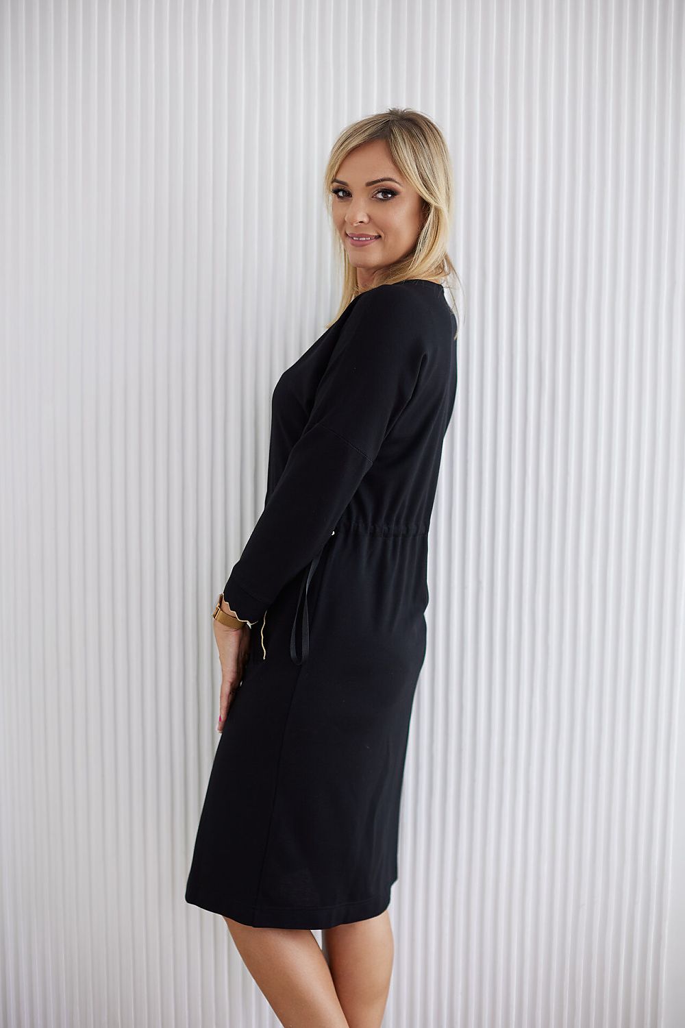 Draped view of La Aurora comfortable knitwear dress, perfect for mature women, emphasizing its graceful silhouette and muted colours.