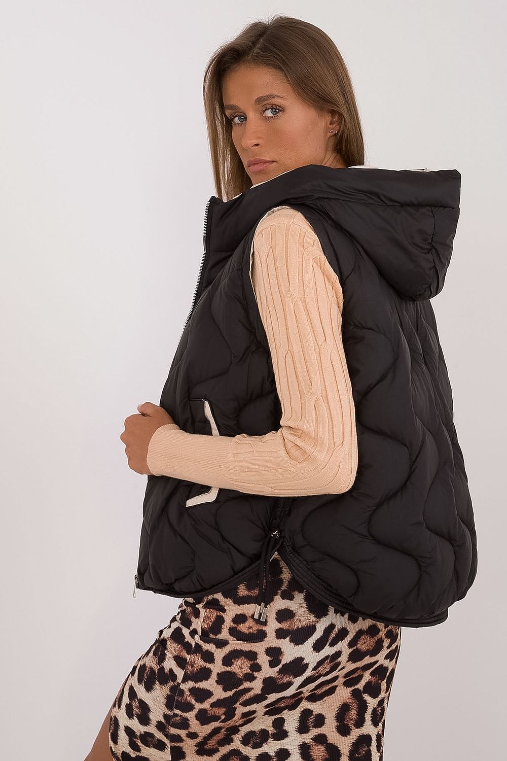 Close-up view of MBM's Luxury Women's Quilted Down Vest featuring a stylish hood and smooth polyester texture, perfect for fashionable cold-weather outfits.