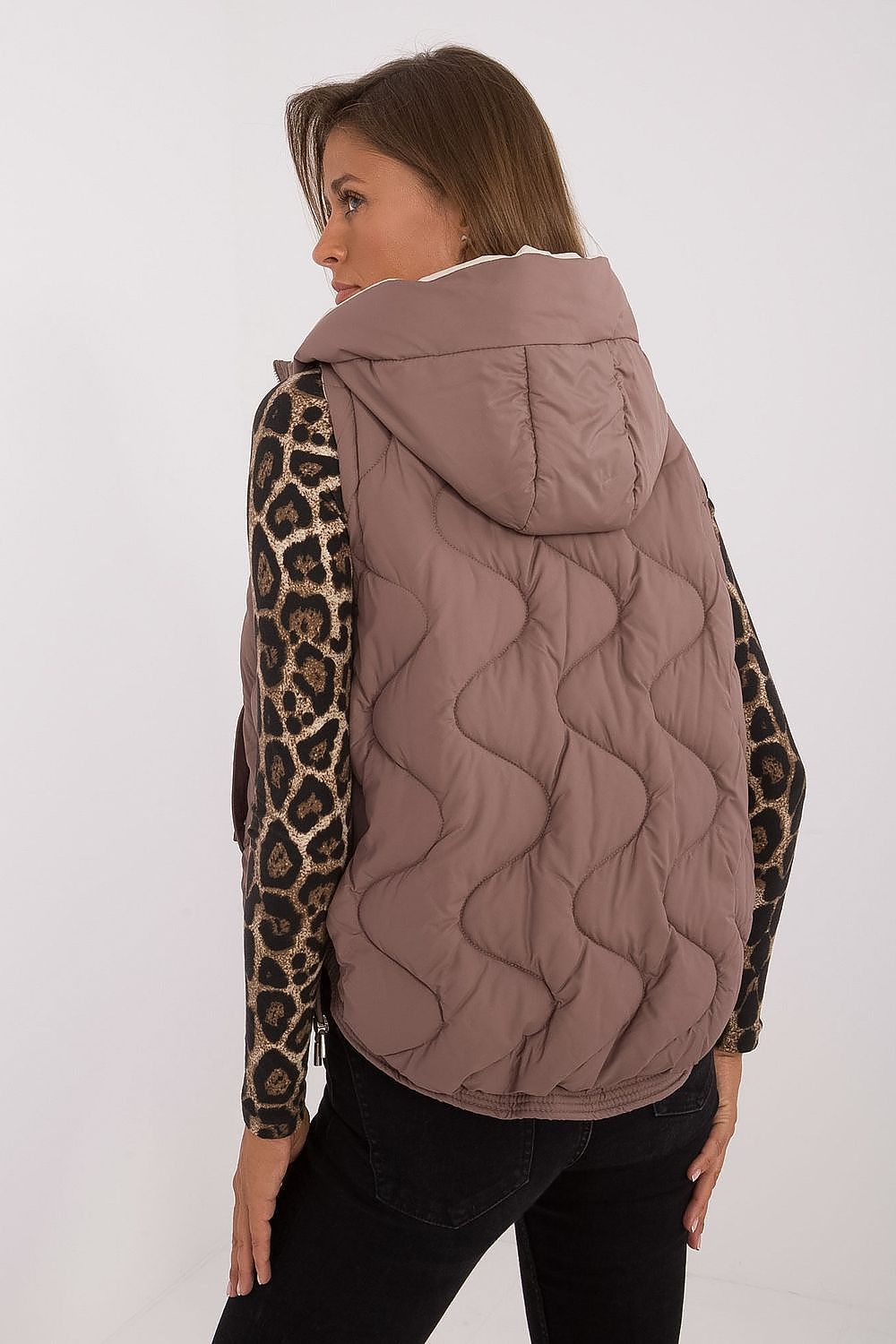 Model wearing MBM's luxury women's quilted down vest with hood, illustrating the perfect blend of comfort and chic style for everyday wear.