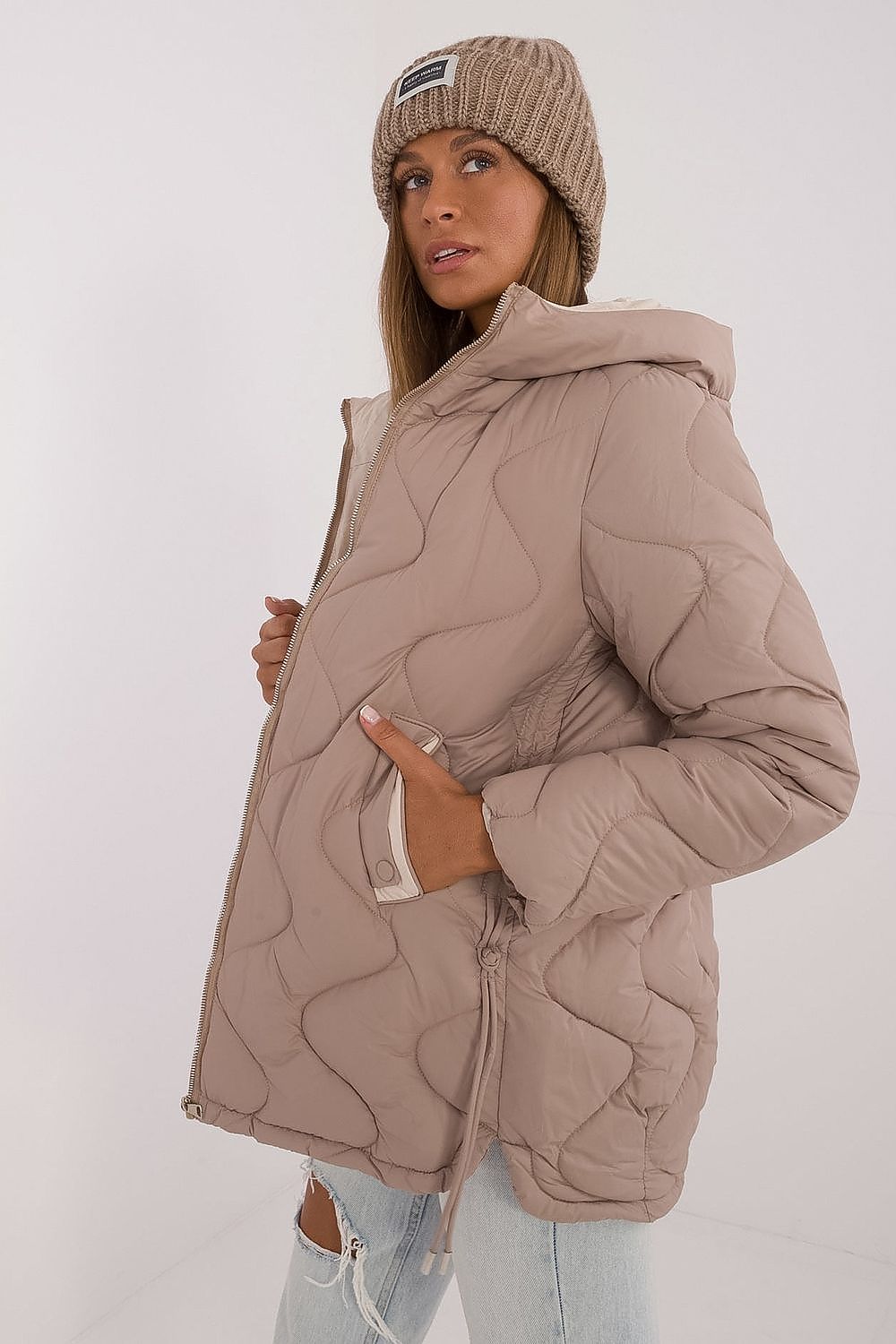 Elegant MBM women's quilted jacket, designed for comfort and style, showcasing practical slip-in pockets and a fashionable hood for cooler seasons.