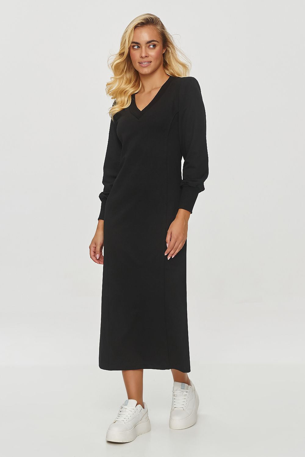 Model wearing the Makadamia midi dress with light puffed sleeves, elegantly styled for a chic and sophisticated look suitable for everyday wear.