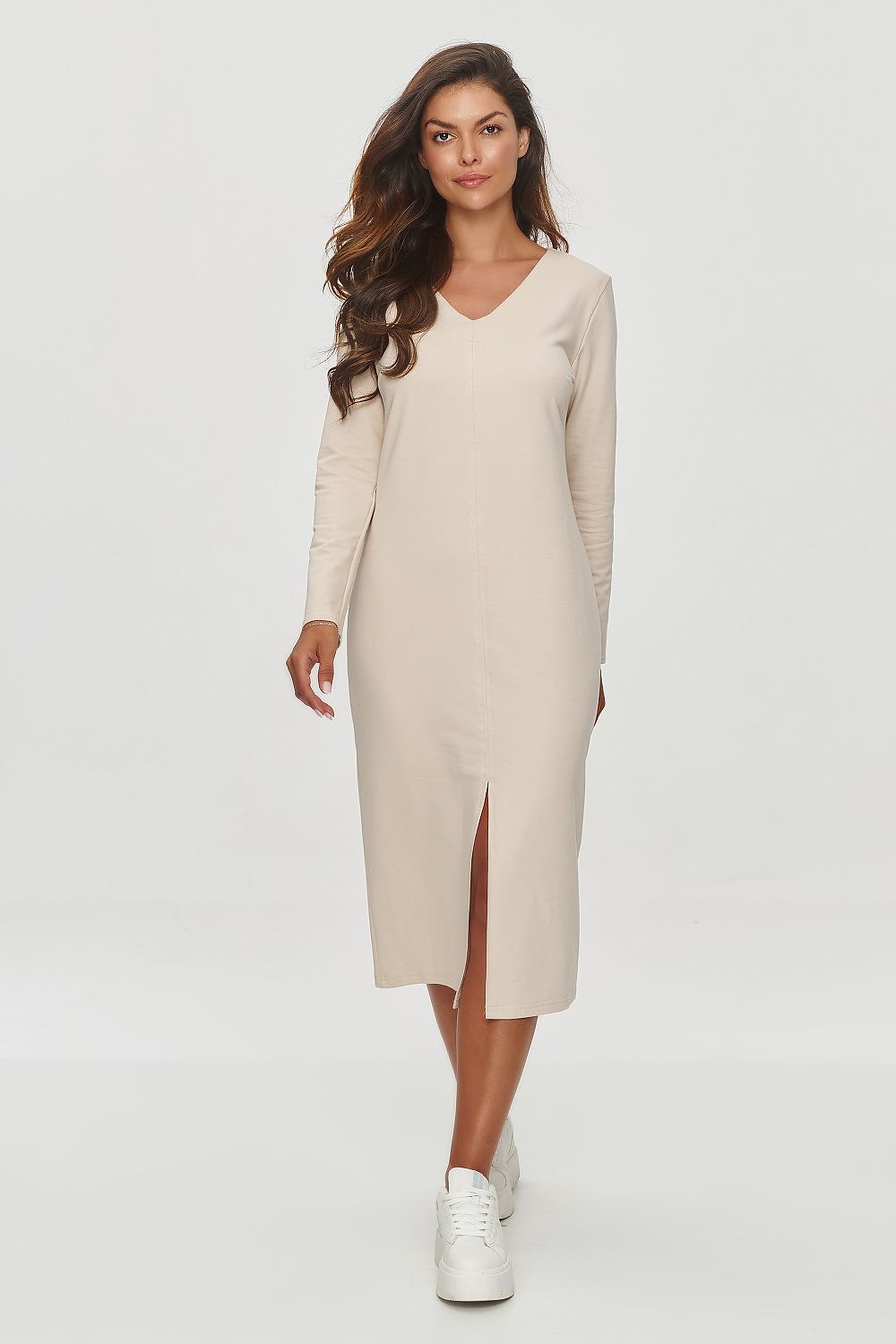 Model showcasing the Makadamia V-Neck Sweatshirt Dress with long sleeves, designed for comfort and elegance, ideal for both casual and formal occasions.
