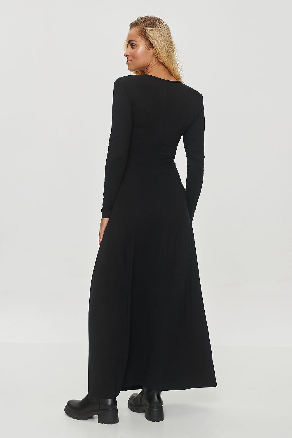 Elegant long dress by Makadamia featuring a fitted design, soft viscose blend, subtle V-neckline, shoulder pads, and a tasteful slit for added femininity and sophistication.