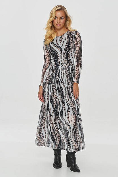 Elegant long printed daydress by Makadamia showcasing flowing, semi-transparent fabric with intricate motifs in warm autumnal colours.