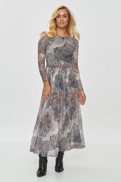 Model wearing the elegant long printed dress by Makadamia styled with ankle boots for a chic, casual look.