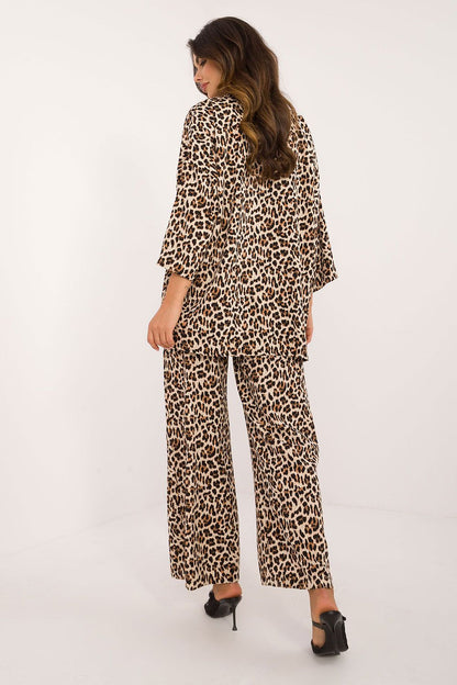 Close-up of Italy Moda's luxury casual wear, highlighting the animal print design on the buttoned shirt and the comfortable fit of the high-waist trousers.