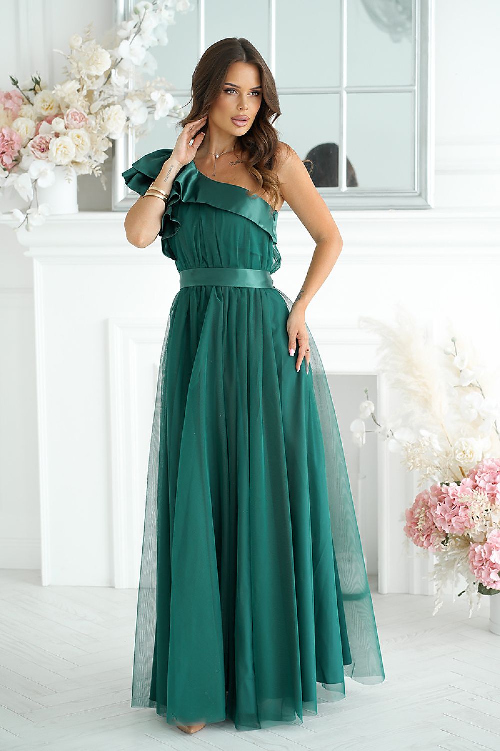 Elegant long dress designed by Bicotone featuring a high slit and satin ruffle, embodying feminine luxury and comfort, perfect for special occasions.