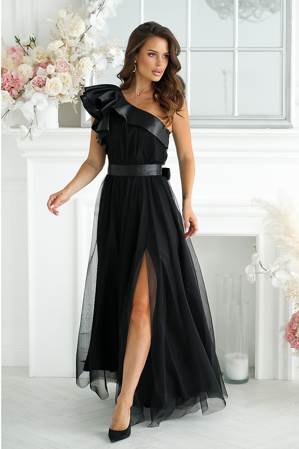 Elegant long dress by Bicotone featuring a high slit and satin ruffle, embodying luxurious femininity and comfort.
