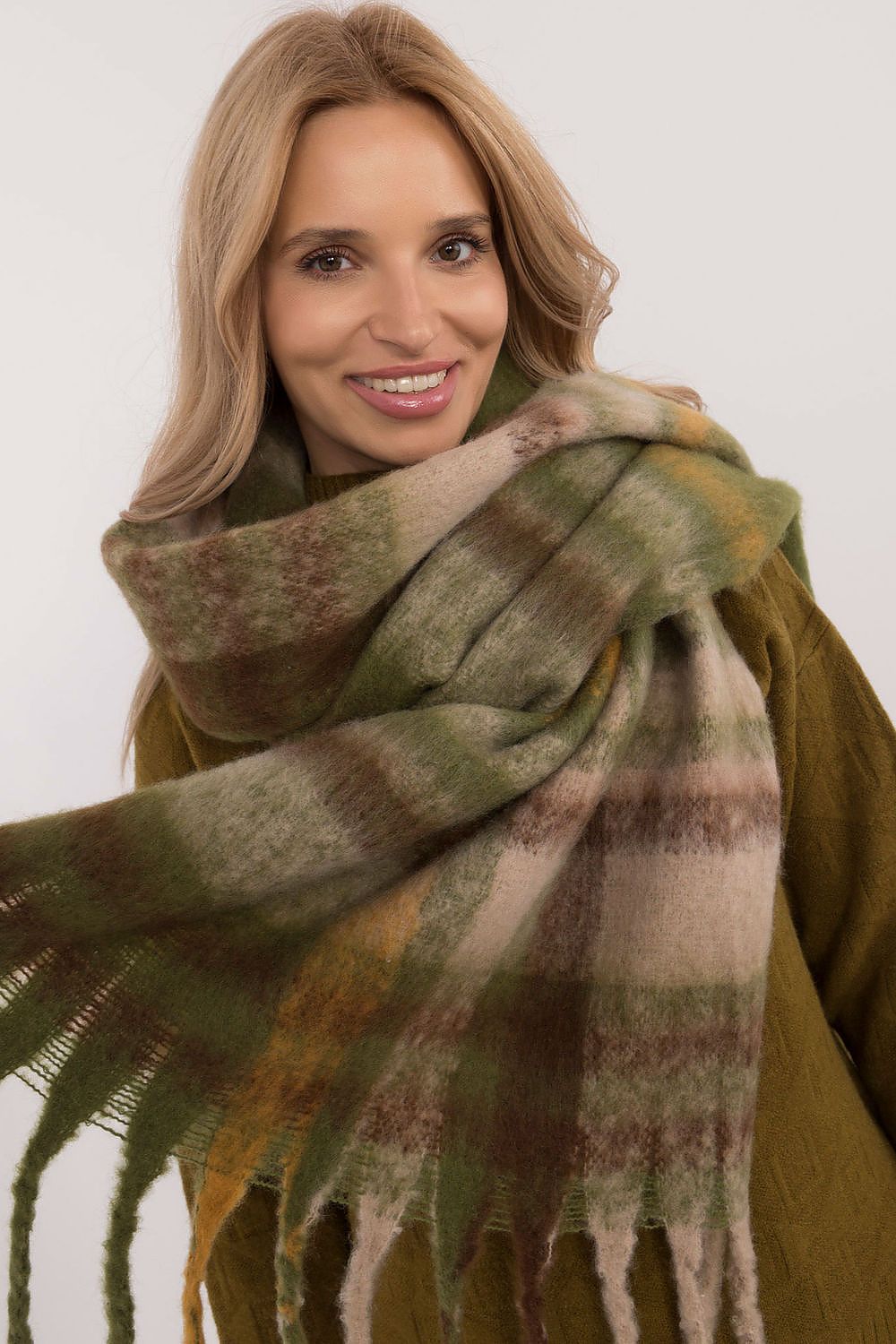 Stylish close-up of AT's elegant polyester check scarf with tassels, ideal for chic winter outfits.