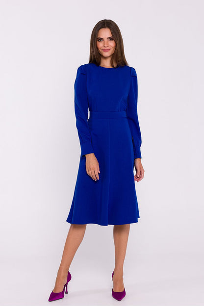 Stylove long sleeve flared day dress in a graceful pose, emphasizing the round neckline and fashion-forward silhouette.