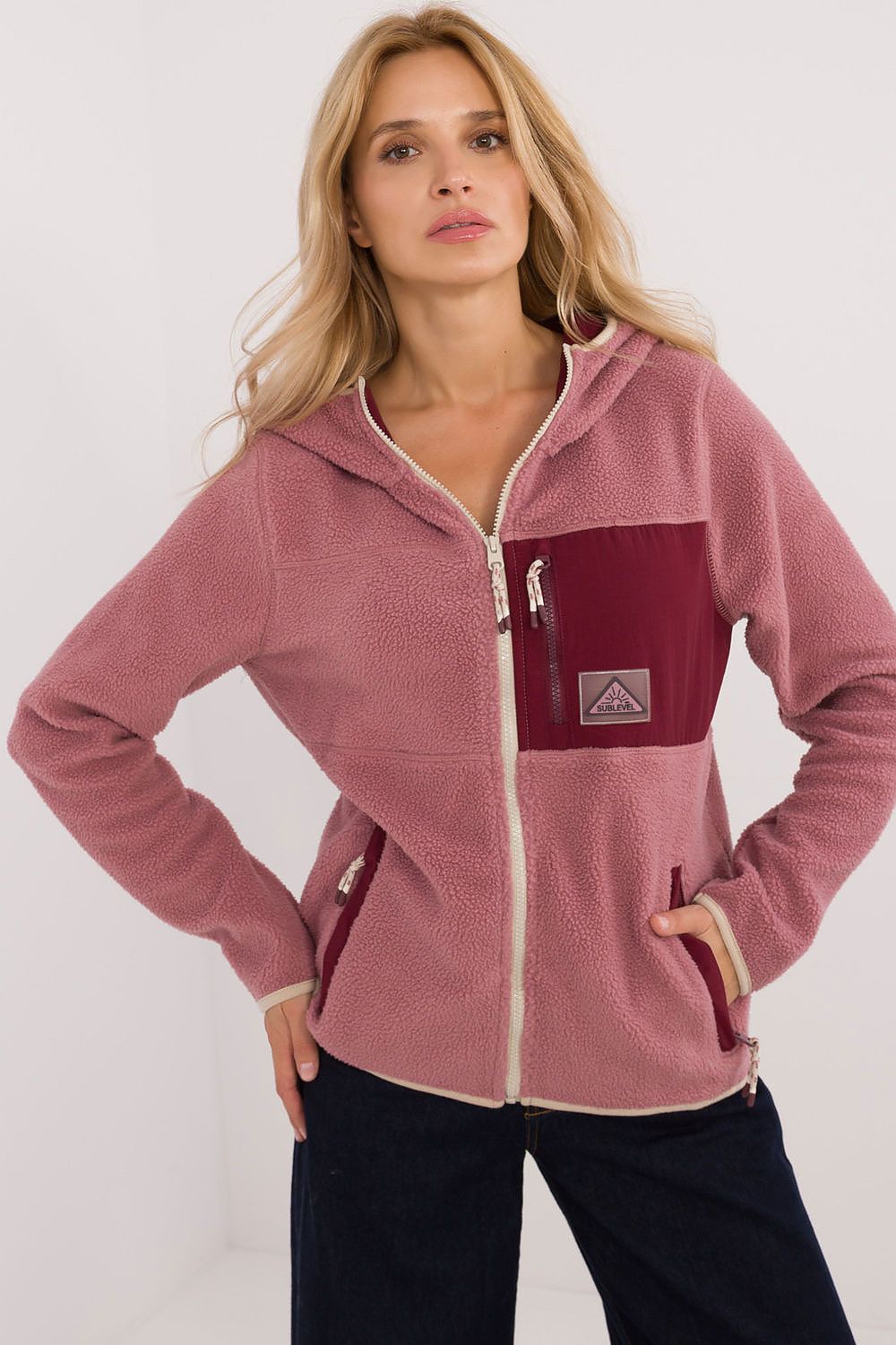 Luxurious women's hooded zipper sweatshirt by Sublevel, showcasing its stylish grey polyester fabric and dual side pockets for a fashionable look.