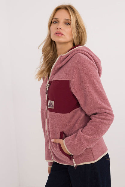 Sublevel women’s hooded zip sweatshirt detailing the elegant long sleeves and practical zippered chest pocket for modern style.