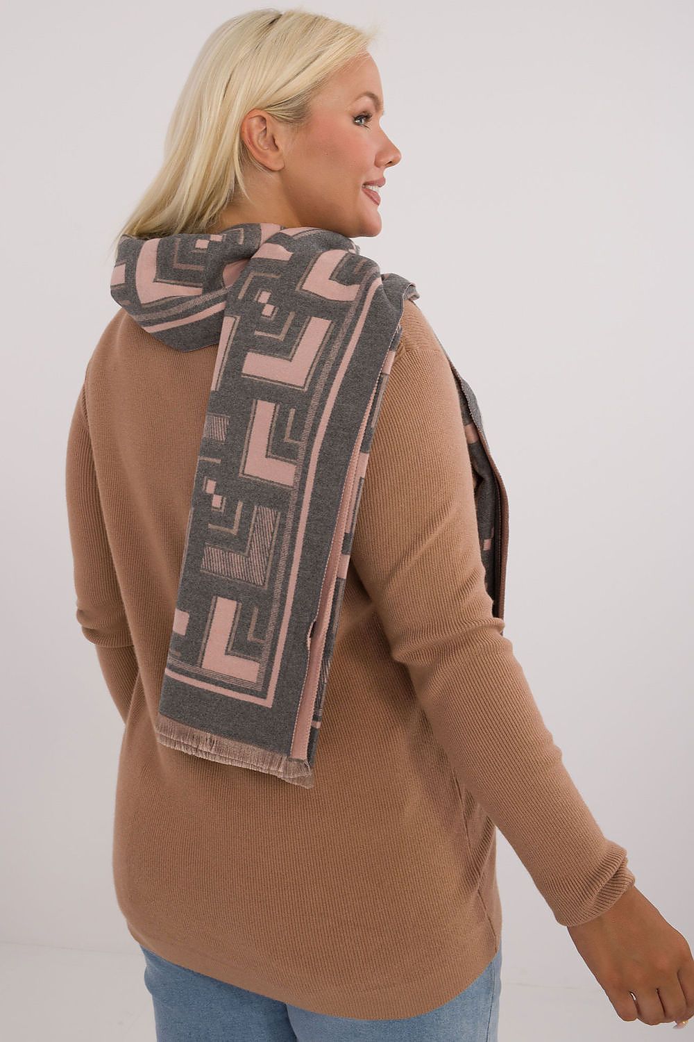 Fashionable model wearing the stylish geometric viscose wool shawl scarf by AT, demonstrating versatile styling for colder weather.