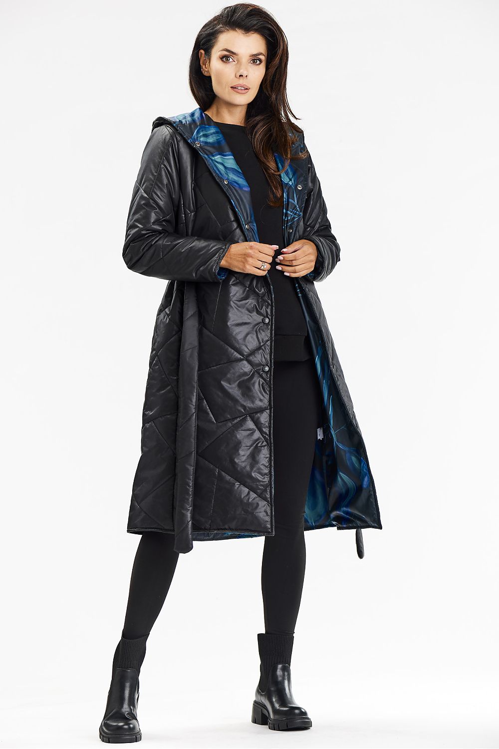 Elegant presentation of Awama's long navy coat, perfect for colder days with its warm quilting and chic design.