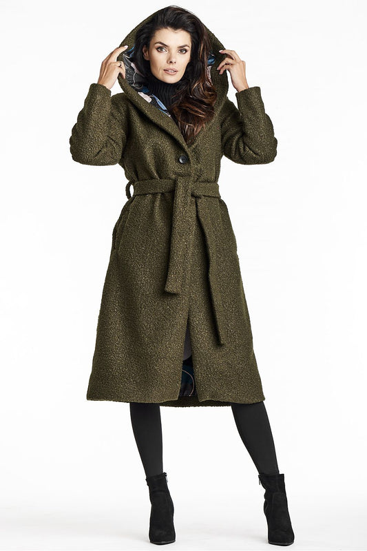Elegant green bouclé coat by Awama featuring a stylish shawl collar, functional hood, and a flattering waist belt, perfect for sophisticated autumn fashion.