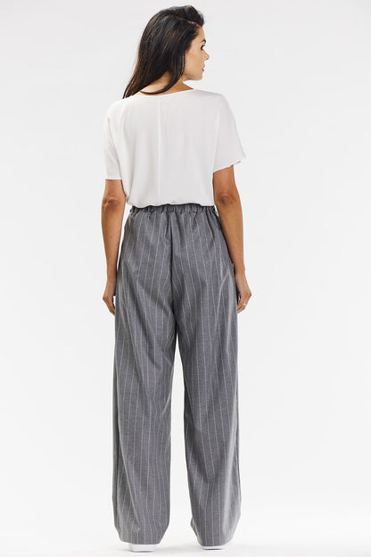 Styling options for Awama's wide-leg trousers in grey with white stripe, featuring fashionable pairing with blouses and footwear.