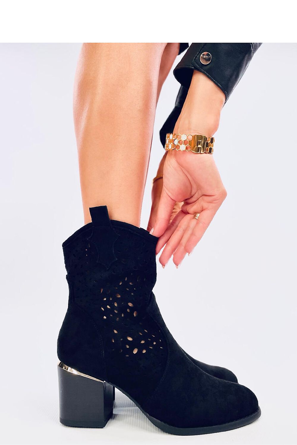 Side view of luxurious eco suede heeled boots by Inello, showcasing intricate openwork upper and 7Cm stable heel with gold accent.