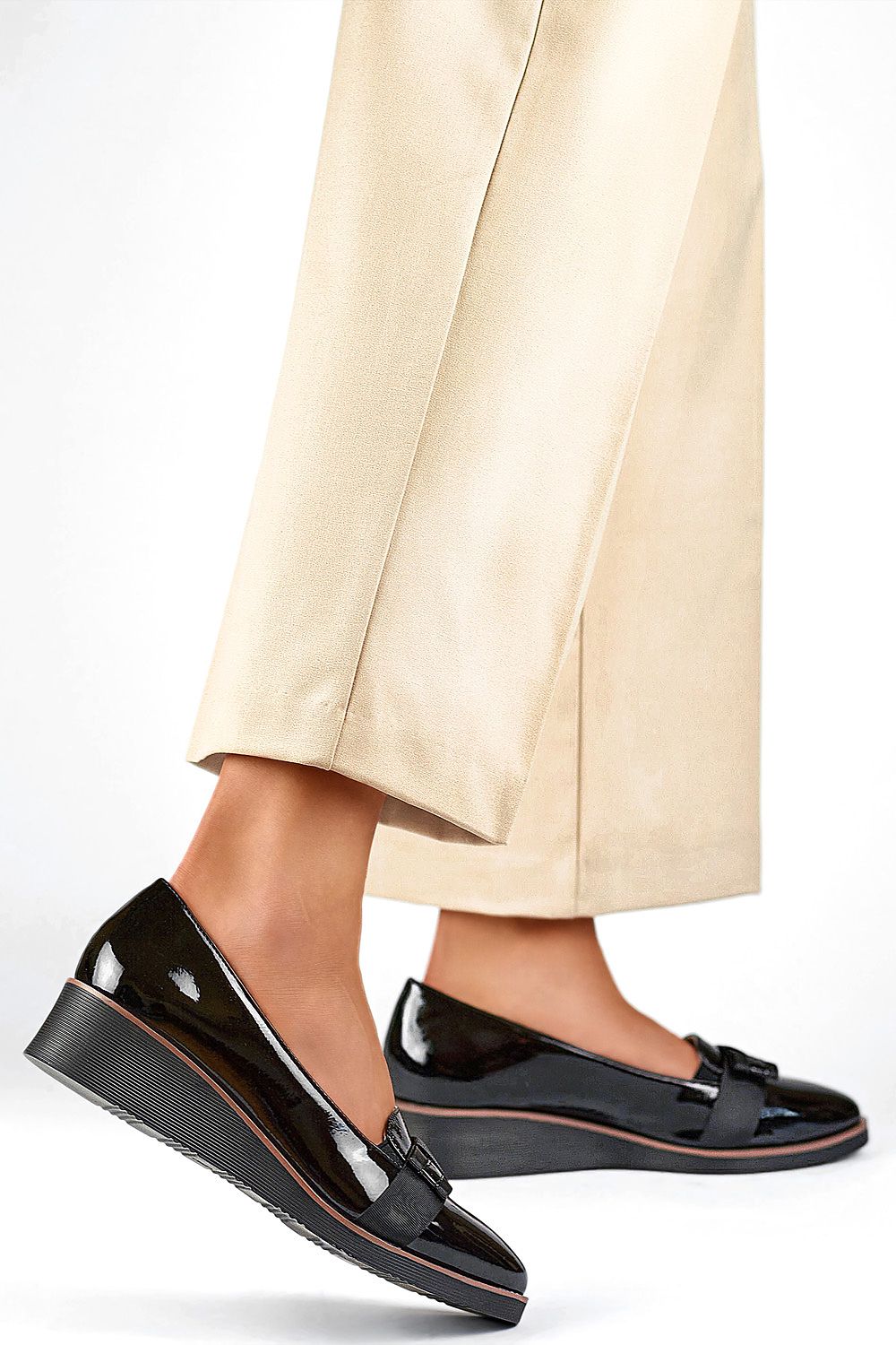Elegant black women's pumps by PRIMO crafted from patent leather, designed for versatility and comfort, perfect for both casual and formal occasions.