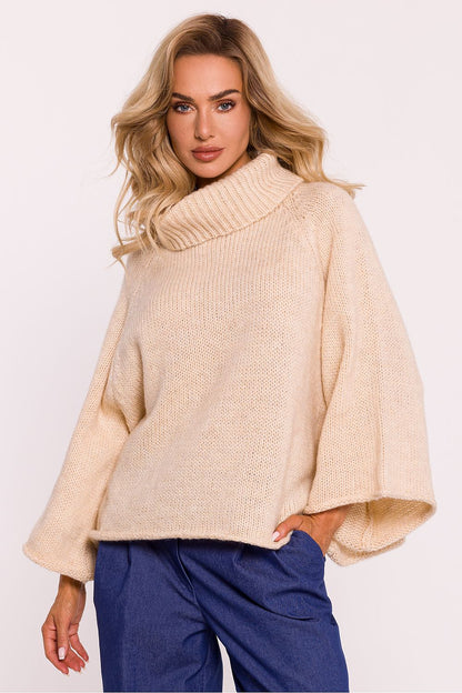 Detail of Moe's oversized turtleneck sweater in soft pile yarn, highlighting its exquisite craftsmanship and comfortable design.