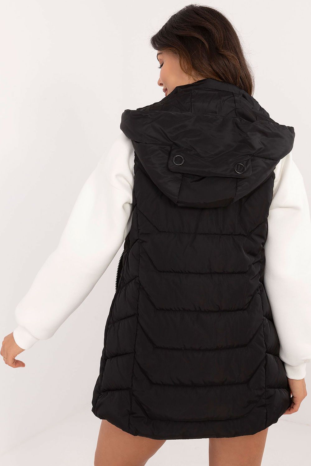 Model showcasing the knee-length quilted vest in a fashionable setting, reflecting the premium quality and modern aesthetics from Factory Price.