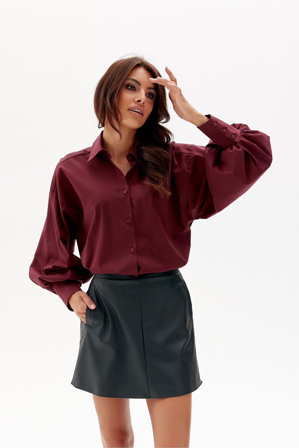 Fashion-forward autumn-winter outfit featuring Roco Fashion's mini leather-like trapeze skirt, paired with an oversized sweater and chic accessories.