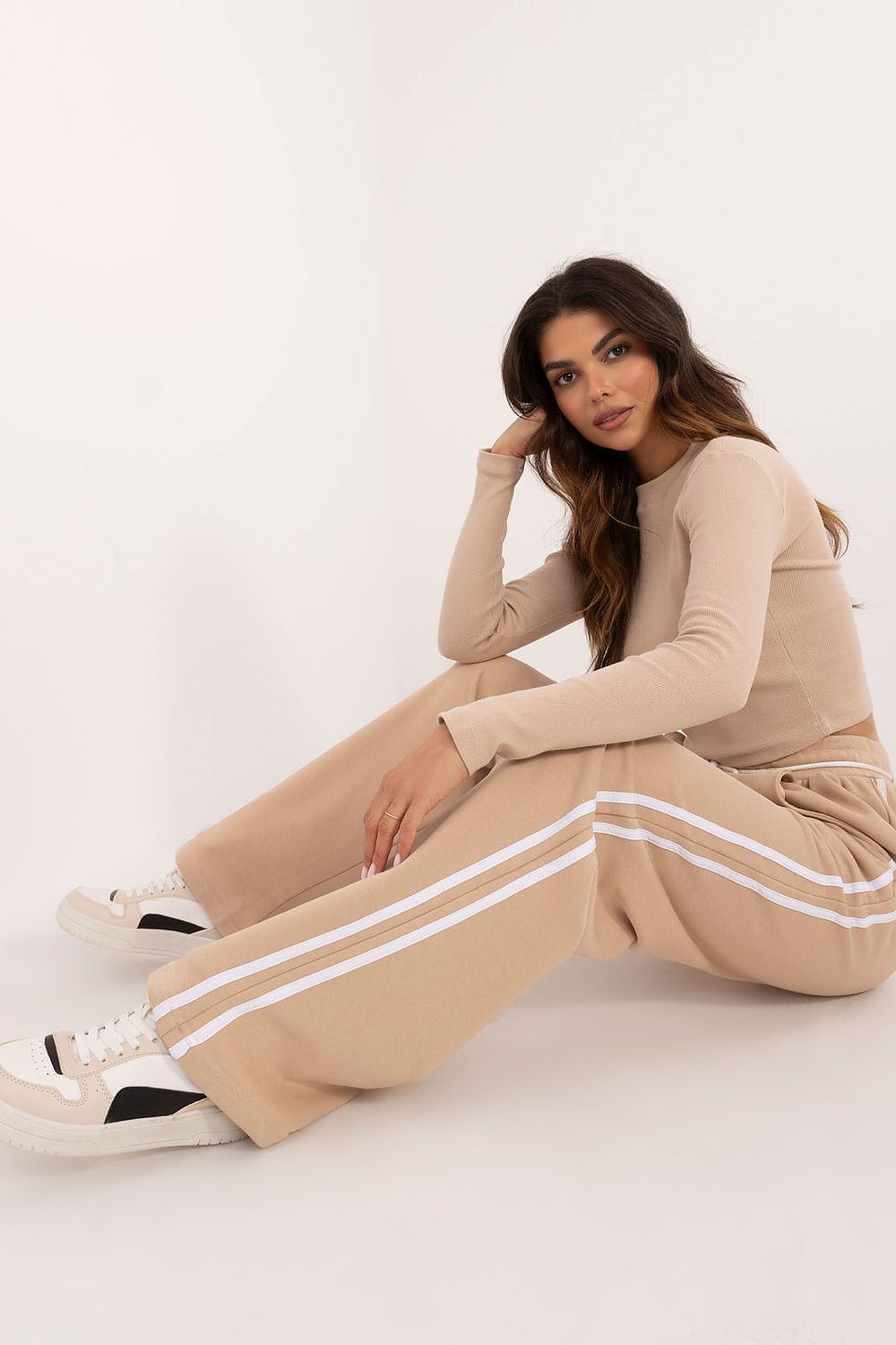 Elegant women's casual sporty set by Factory Price featuring a long sleeve blouse and high-waisted trousers, designed for comfort and style.
