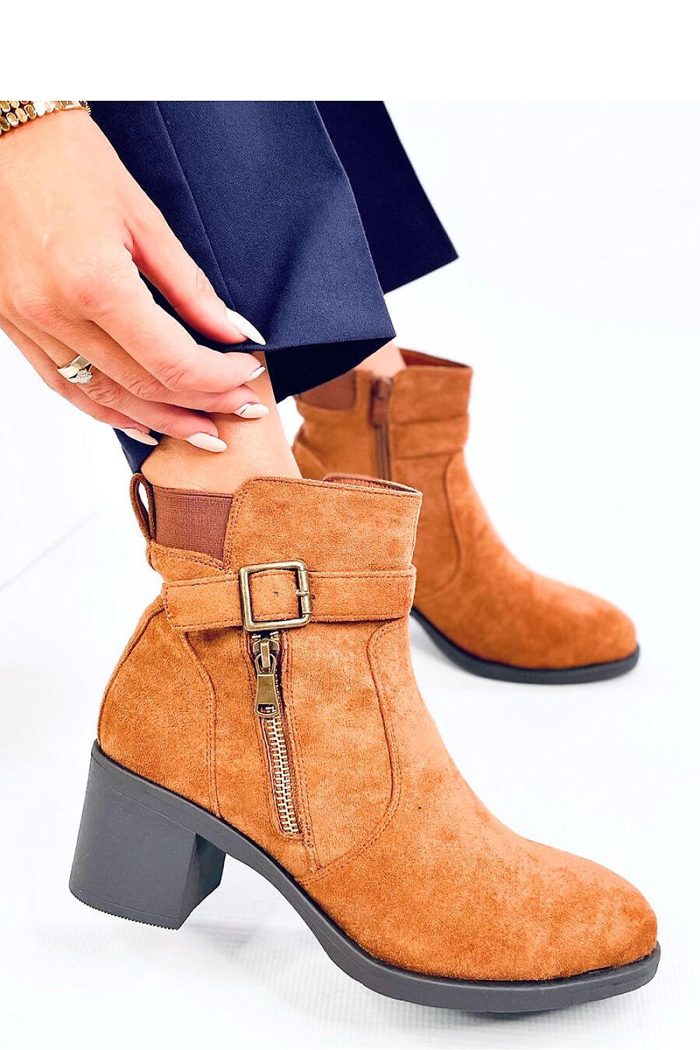 Stylish close-up of Inello women's eco-suede boots showcasing the delicate buckle and soft fur interior for added luxury and comfort.