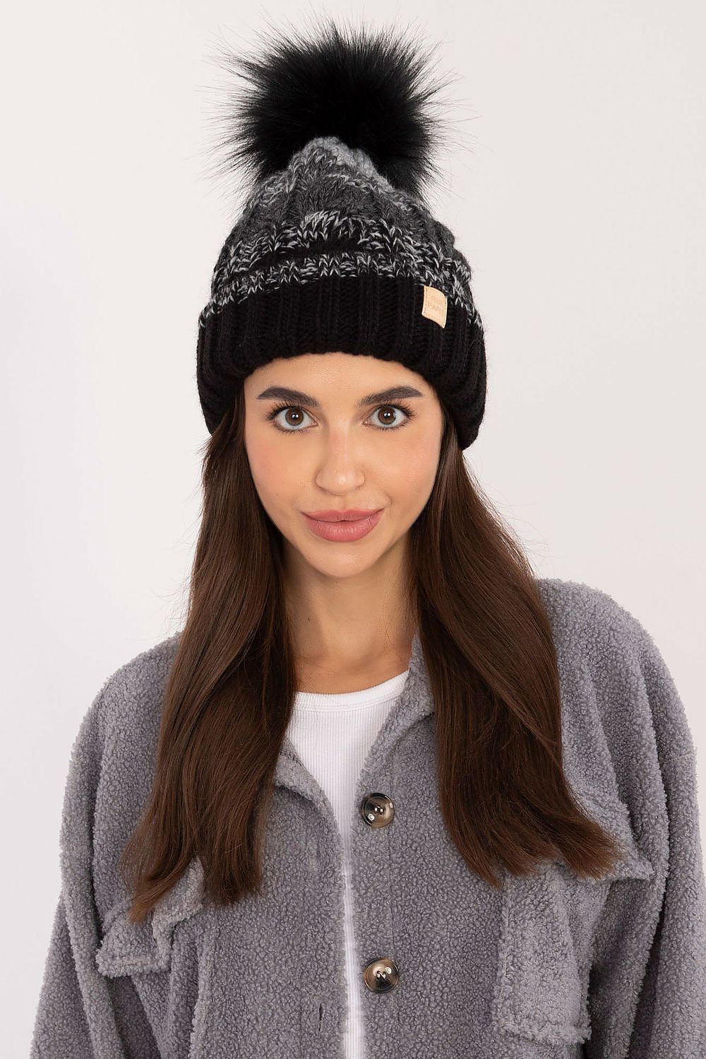 Rue Paris winter beanie illustrated in an outdoor setting, emphasising its fashionable plaid design and cozy fleece inner lining for ultimate warmth.