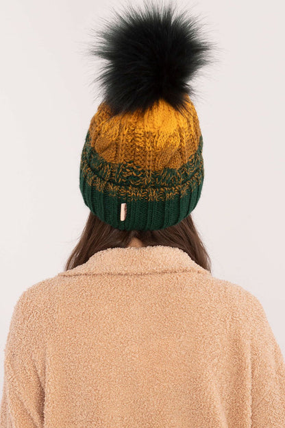 Close-up of the Rue Paris winter beanie showcasing its soft acrylic, polyamide, and wool blend material, featuring a chic plaid design and a cozy pom-pom detail.