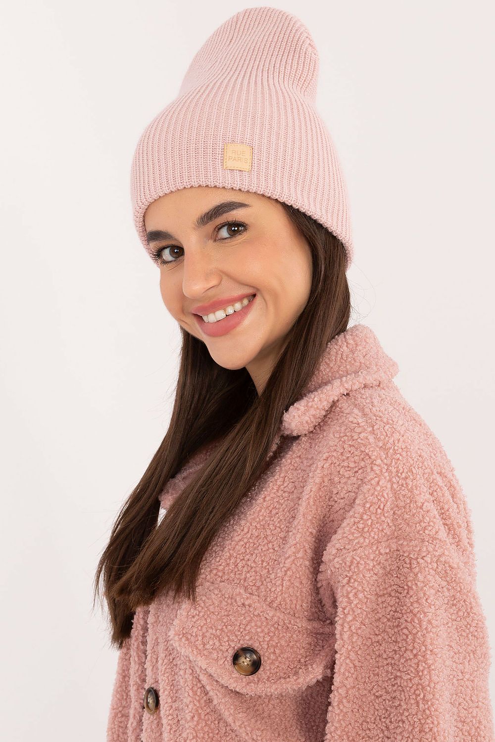 Model wearing the Classic Acrylic Beanie Hat by Rue Paris, demonstrating its versatility and fashionable appeal in a casual outdoor setting.