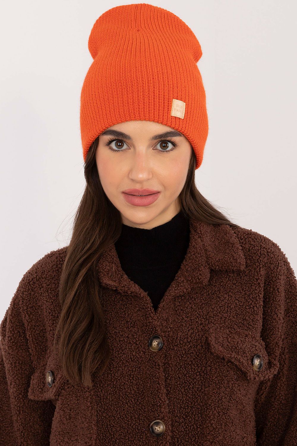 Classic Acrylic Beanie Hat by Rue Paris arranged aesthetically, reflecting its soft material and classic beanie cut, perfect for everyday wear.