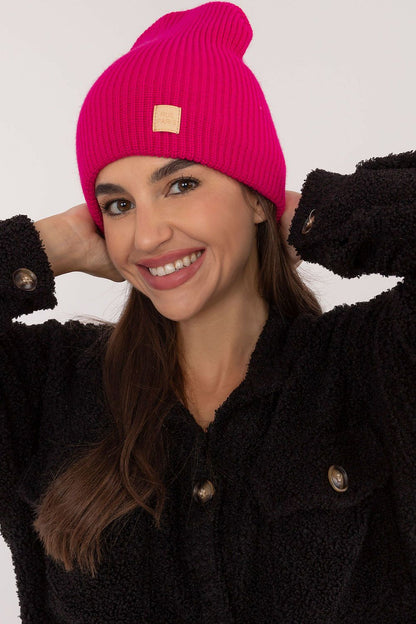 Chic and fashionable Rue Paris beanie hat, featuring a discreet character patch, ideal for enhancing a luxurious look.