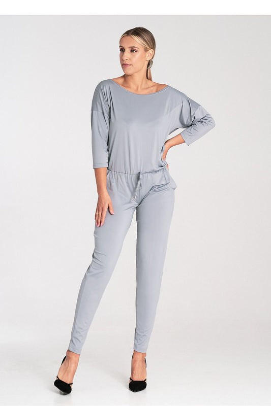 Elegant luxury Figl loose-fitting jumpsuit with tapered legs, tied waist, and sophisticated boat neckline, showcasing timeless styling for modern elegance.