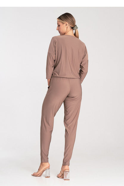 Model wearing the luxurious Figl jumpsuit with drawn waist and tapered legs, highlighting the sophisticated silhouette.