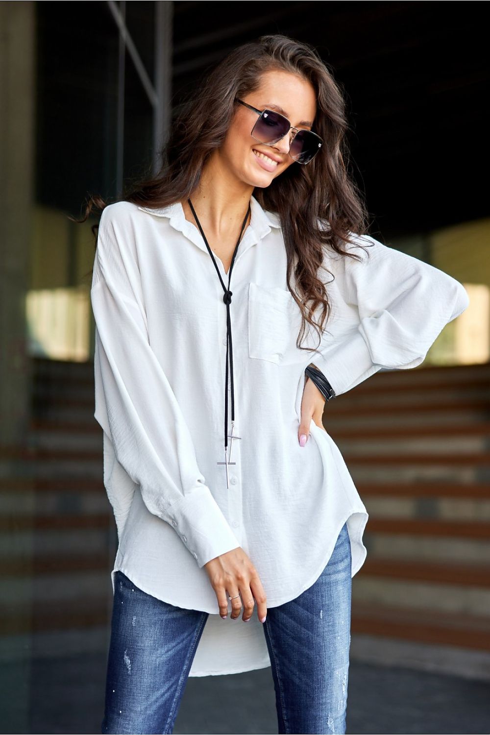 Stylish close-up of the unique long sleeves and cuffs of the Roco Fashion asymmetrical oversized women's shirt, showcasing its relaxed fit and sophisticated design.