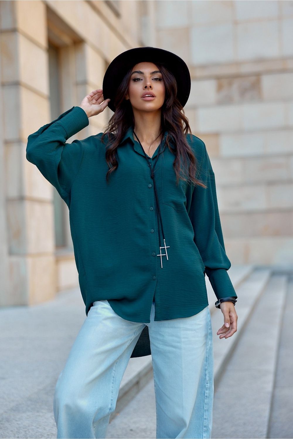 Roco Fashion's oversized women's shirt paired with stylish footwear, demonstrating versatility for various occasions.