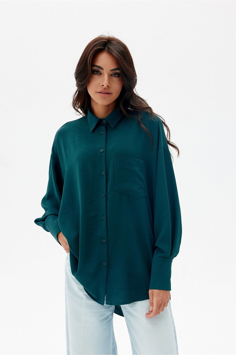 Casual yet chic styling of Roco Fashion's classic collar asymmetrical oversized women's shirt, paired elegantly with jeans for a sophisticated look.