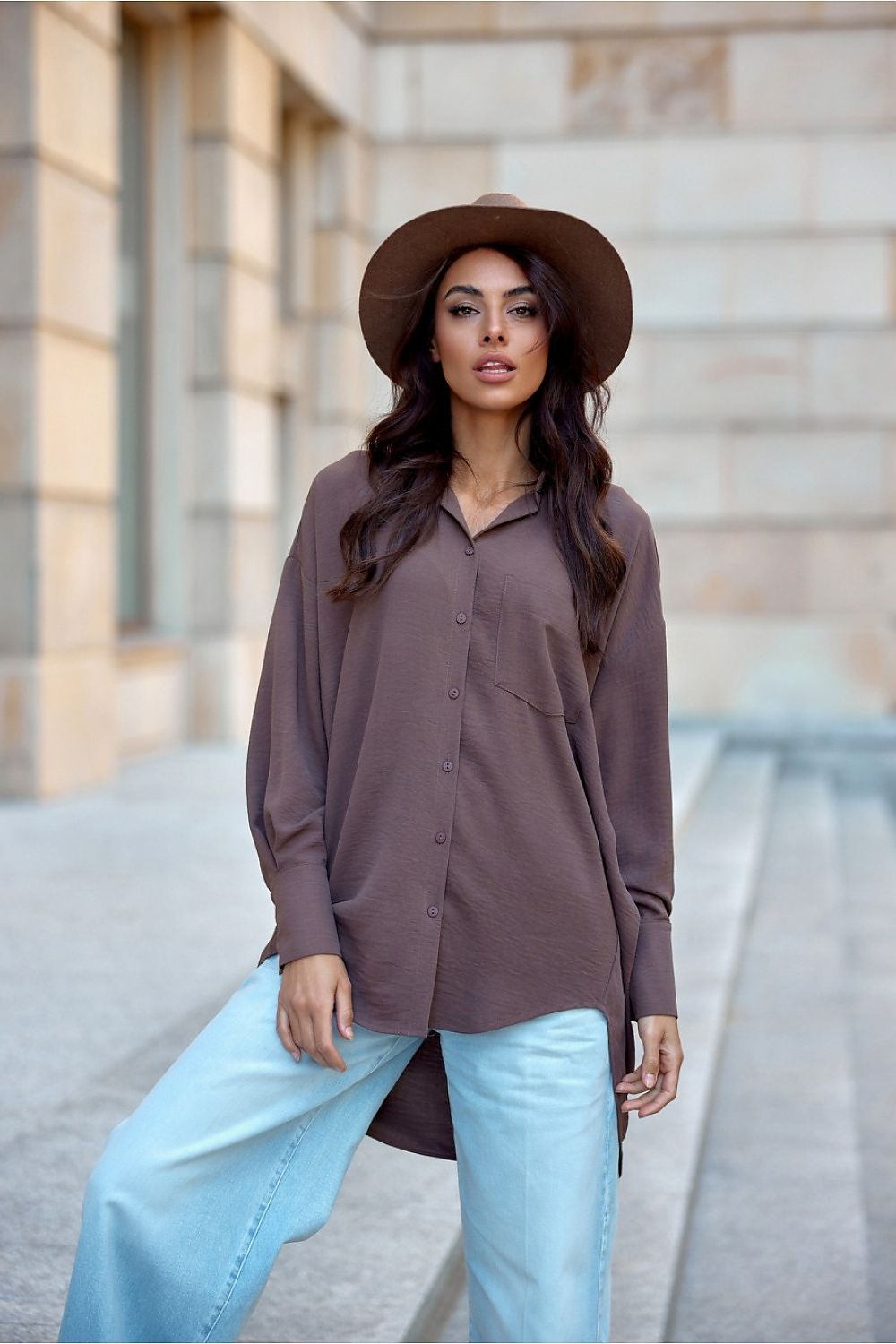Versatile asymmetrical oversized long sleeve shirt for women from Roco Fashion, featuring a front pocket and relaxed style suitable for various occasions.