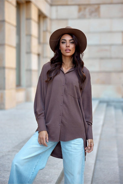 Versatile asymmetrical oversized long sleeve shirt for women from Roco Fashion, featuring a front pocket and relaxed style suitable for various occasions.