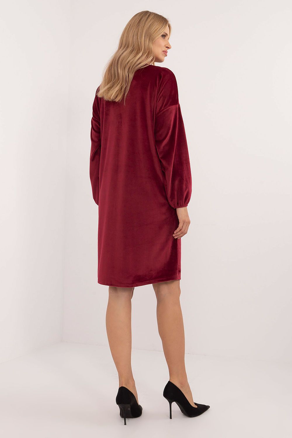 The elegant velour daydress by Italy Moda displayed on a model, featuring long sleeves and an eye-catching heart neckline for a fashionable look.