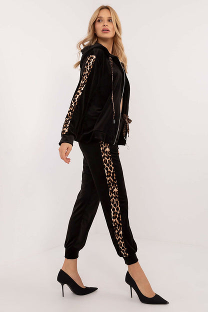 Luxurious women's velour set by Italy Moda featuring a stylish blouse with animal-pattern stripes and high-waisted pants, perfect for casual elegance.