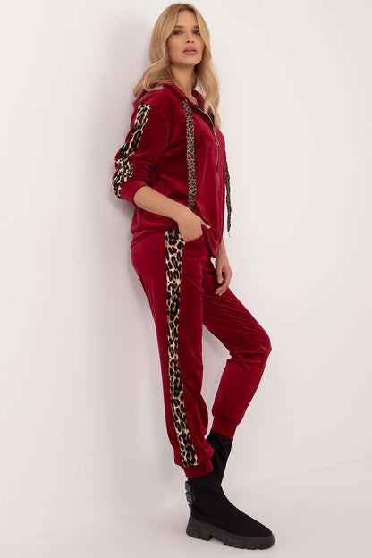 Close-up of Italy Moda's women's velour set showing the rich texture and animal-pattern details on the blouse and pants, ideal for sophisticated outings.